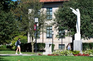 campus in fall foliage with statue