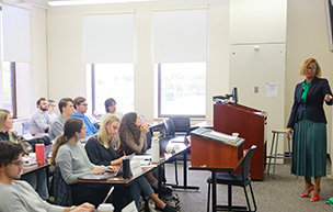 Law students sit in a classroom while a professor teaches.
