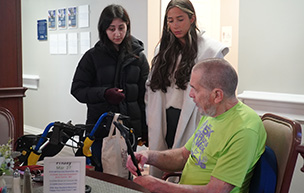Two students work with a client during the Faces on Design capstone project