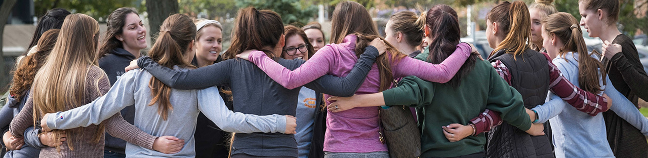 group of female students gathered around the fisher fountain