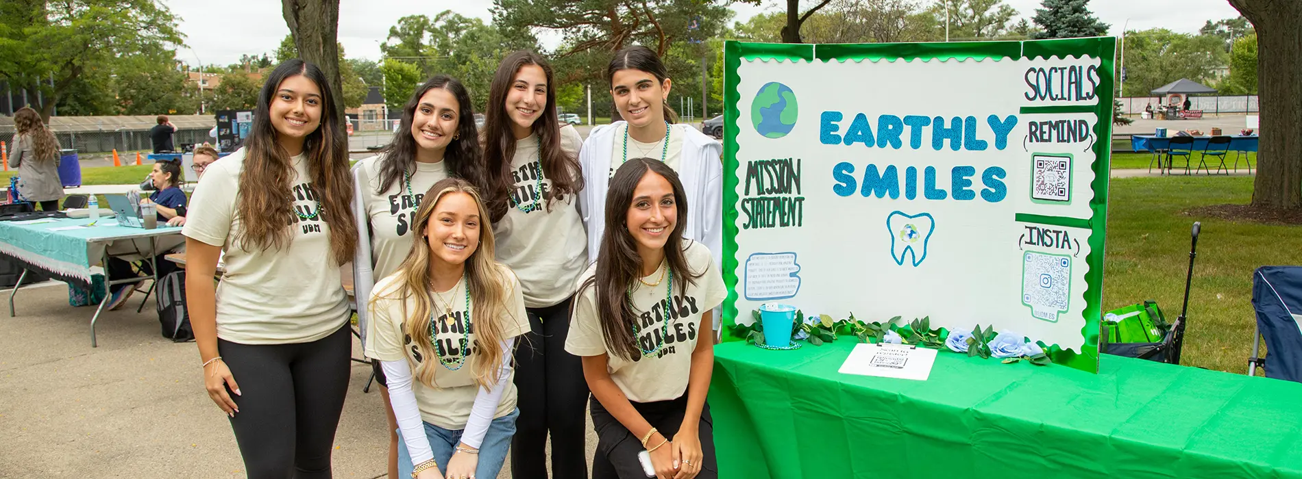 six members of the earthly smiles group at their information table