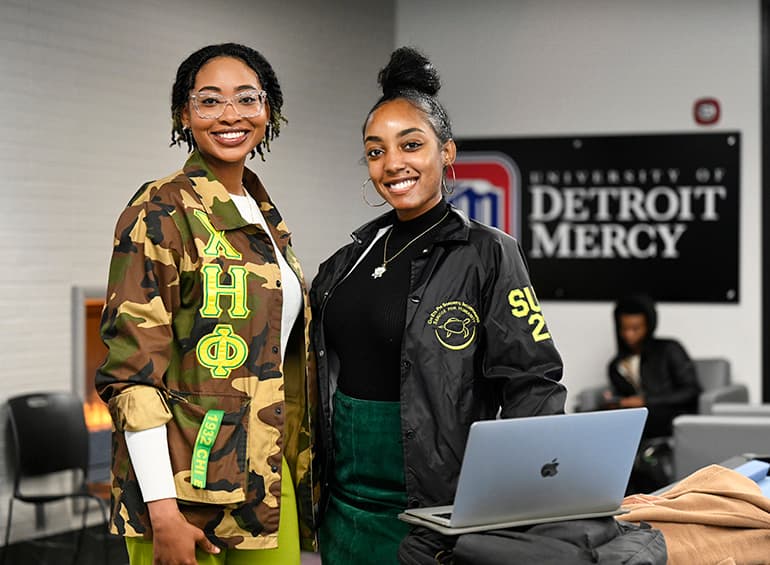 two sorority students posing and smiling