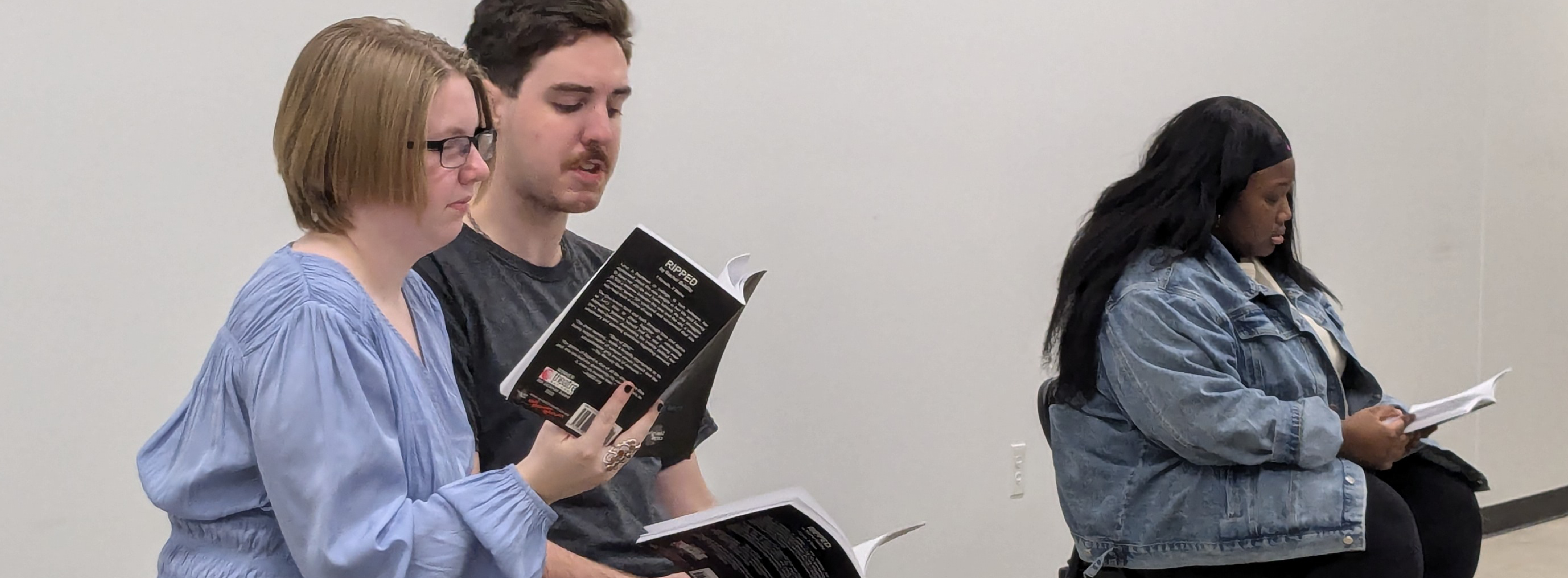 Image of actors in motion on a stage