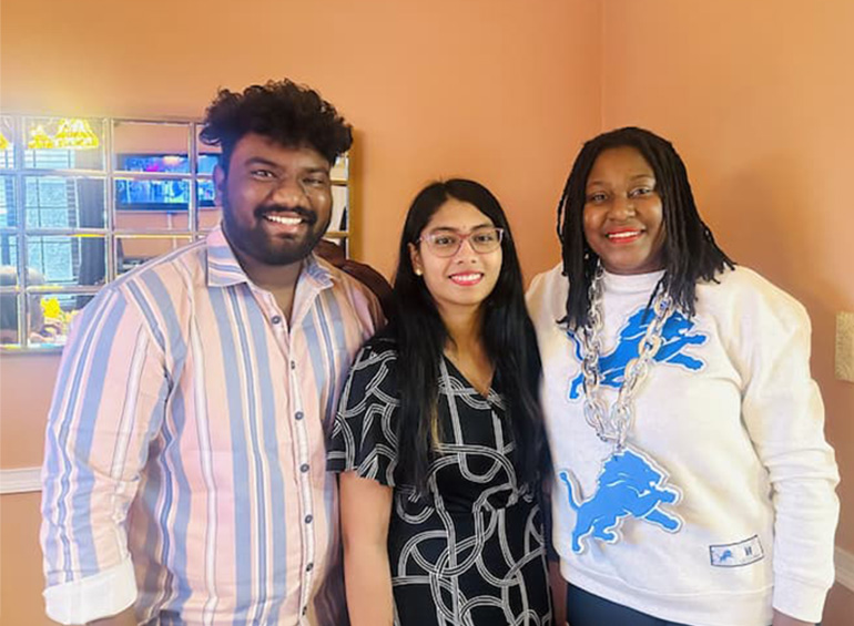 An image of three people standing together