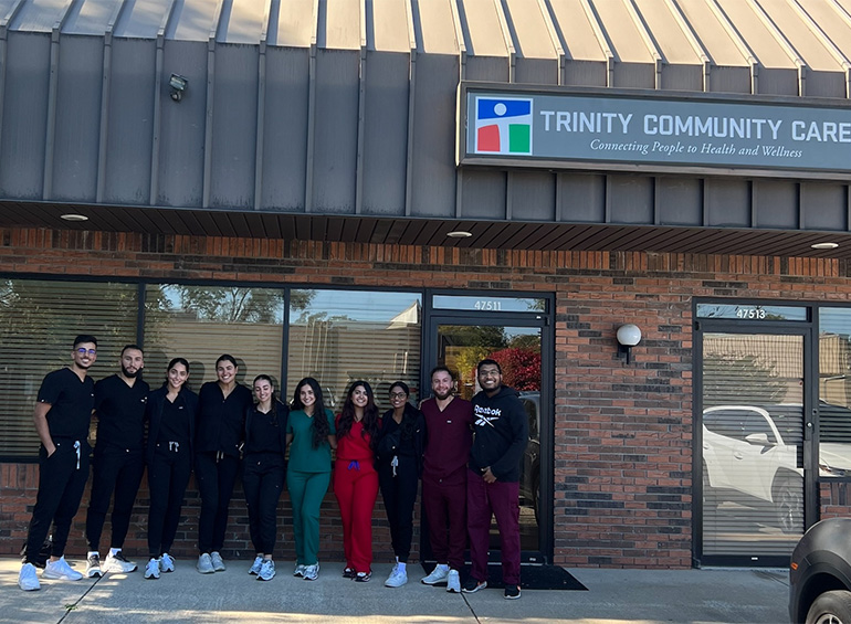 Image of UDM students outside Trinity Healthcare office