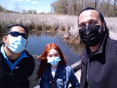 Cynthia Gutiérrez Navarro, Adrian Vasquez (Healthy Urban Waters Director of the Lake St. Clair Metropark field station) and Detroit Mercy professor Victor Carmona poses for a photo at Lake St. Clair Metropark during the start of their summer project.