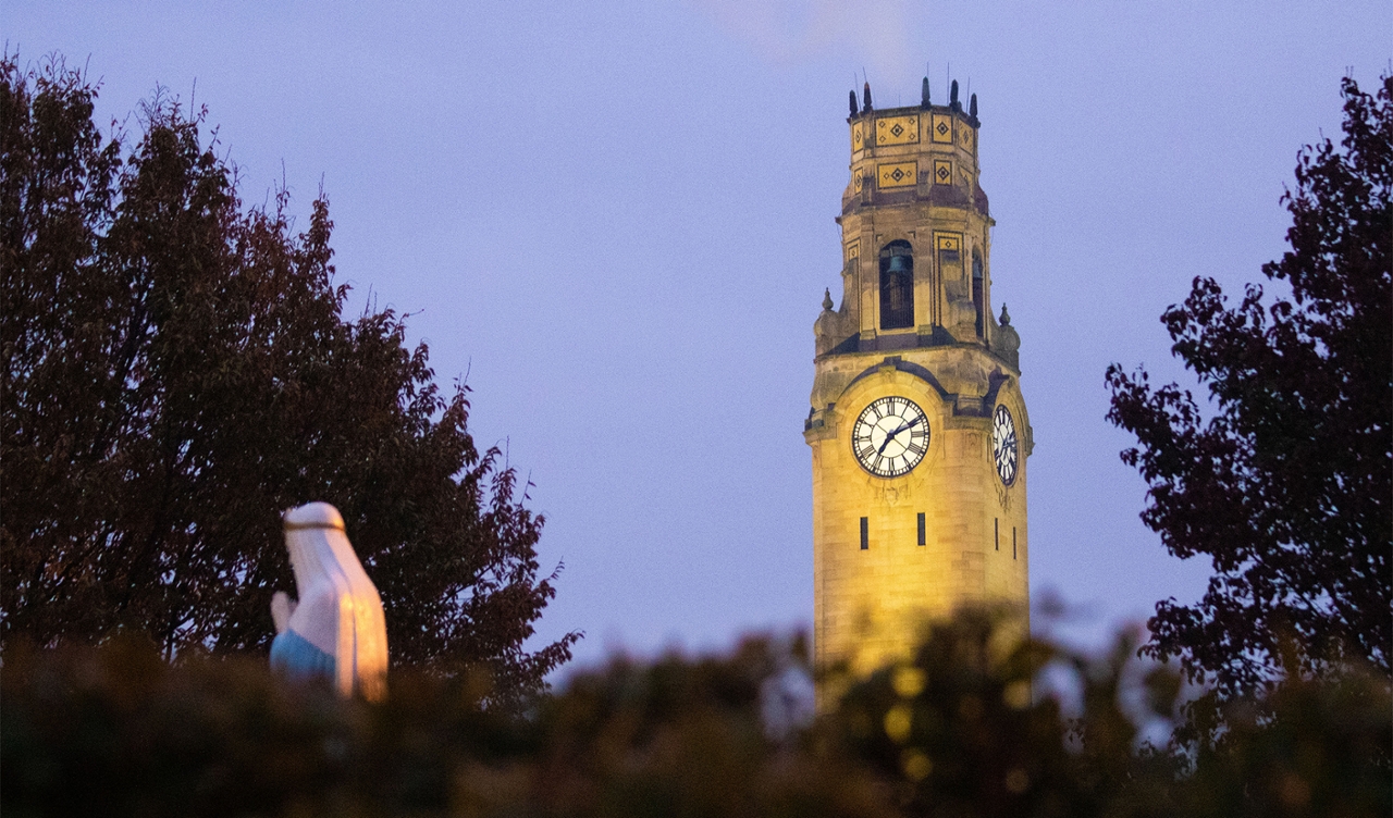 The clock tower on Detroit Mercy's McNichols Campus, pictured at night.