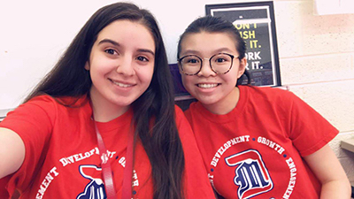 A photo of Coryn Le with a classmate, who are both wearing Detroit Mercy shirts.