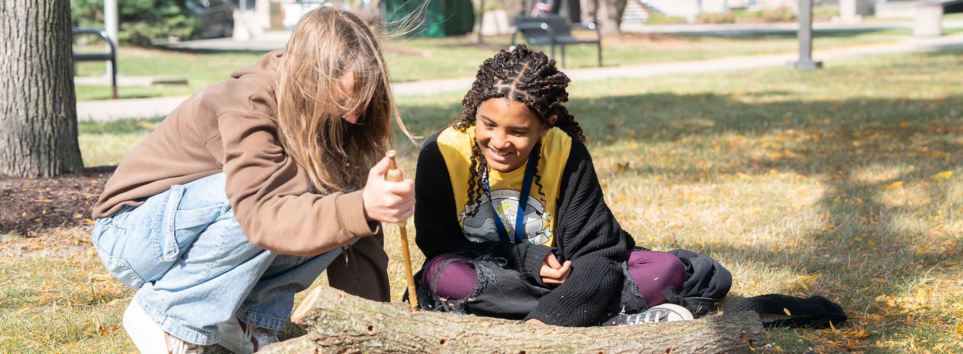 More than a half-dozen students sit inside and work on an activity during the Bioneers conference.