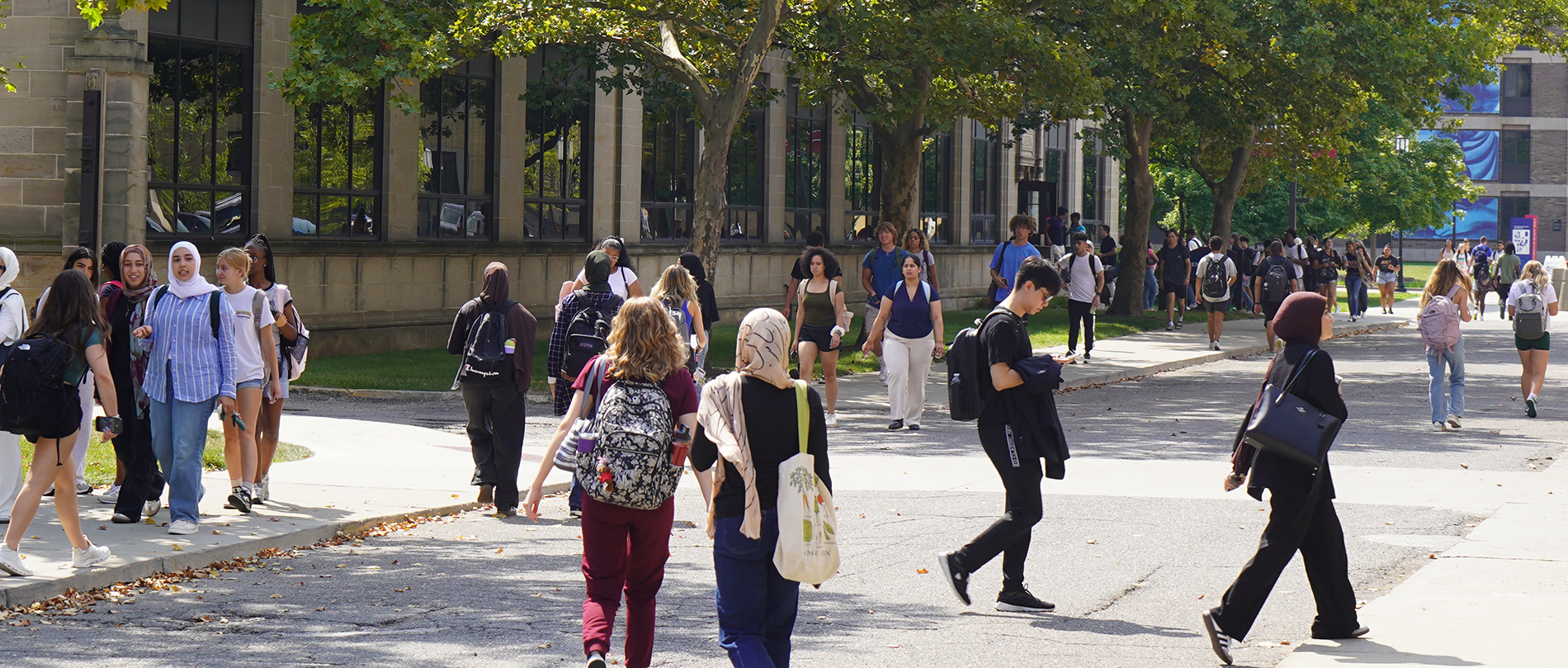 Dozens of students walk on the McNichols Campus during the first day of classes.