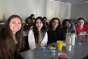 Commuter Student Association students sit together in a classroom as they watch a movie.