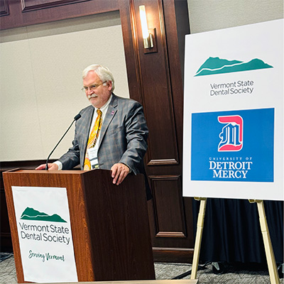 Detroit Mercy School of Dentistry Dean Mert N. Aksu speaks at a press conference announcing a collaboration between Vermont State Dental Society and University of Detroit Mercy. 