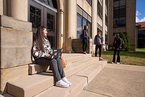 Students gather on the steps outside of the Engineering Building.