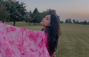 Nisha Miah poses in a pink shawl.