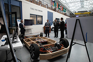 U.S. Sen. Peters and National Cyber Director Harry Coker Jr. look at a vehicle during a visit to UDM's College of Engineering & Science.