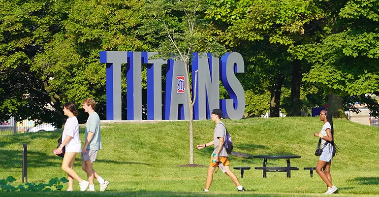 students in front of Titans letters