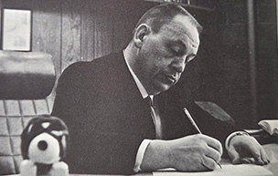 Dean Lawrence Canjar writes at his desk.