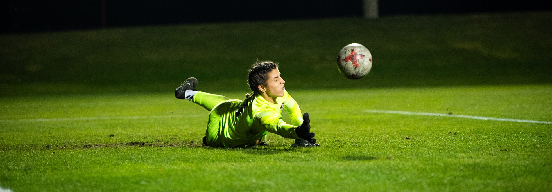 Marisa Silver makes a diving save during a soccer game.