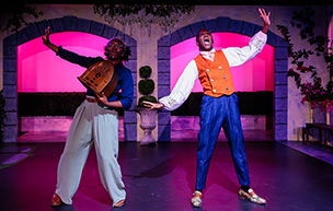Two actors sing and perform inside of the Black Box Theatre at University of Detroit Mercy.