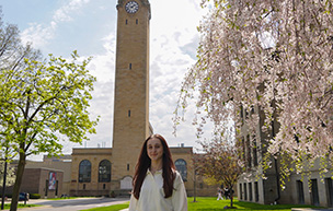 Victoria King stands in front of UDM's Clocktower.