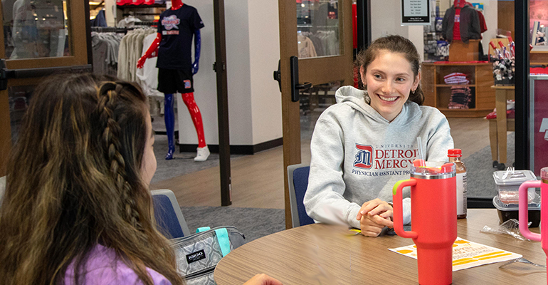 Students chatting in at a table