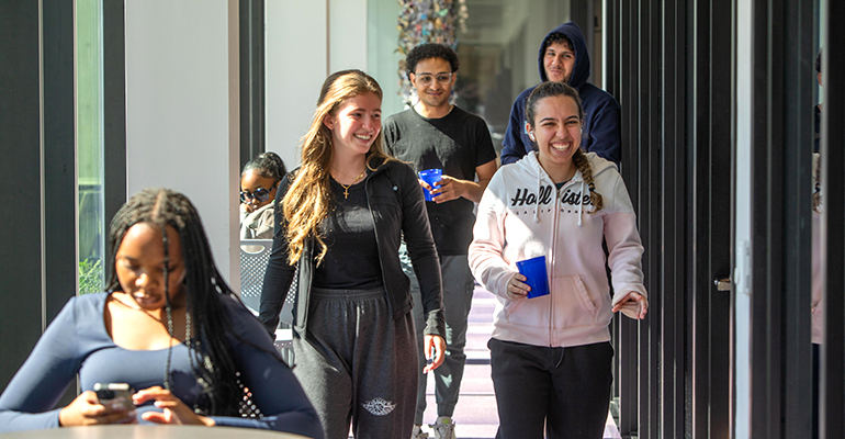 several students walking down a hall