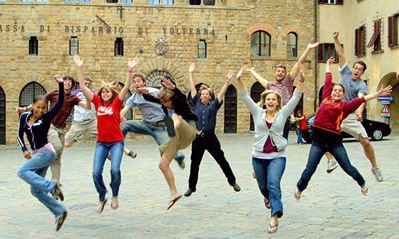 Students in Italy jumping up