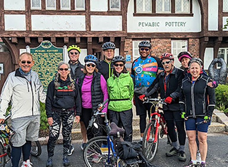 10 or so alumni on bikes downtown