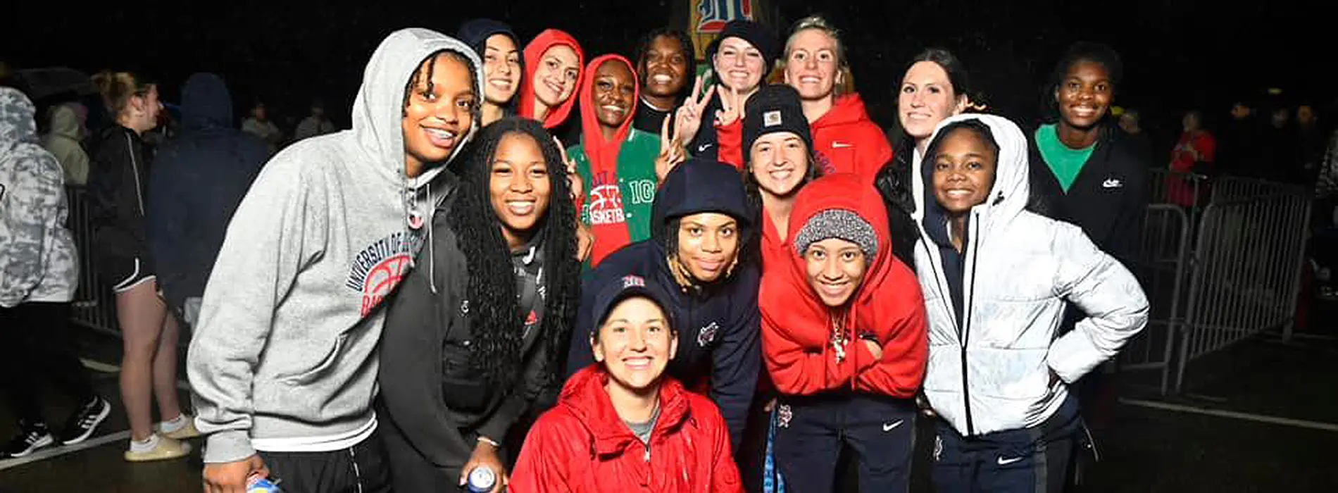 a group of young alumni or students at an evening homecoming activity