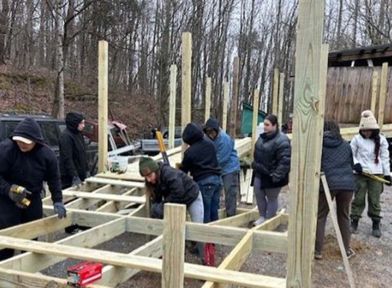 students building a platform during a service immersion trip