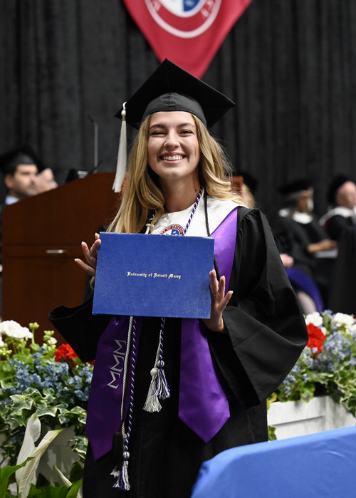 Graduate standing with diploma cover