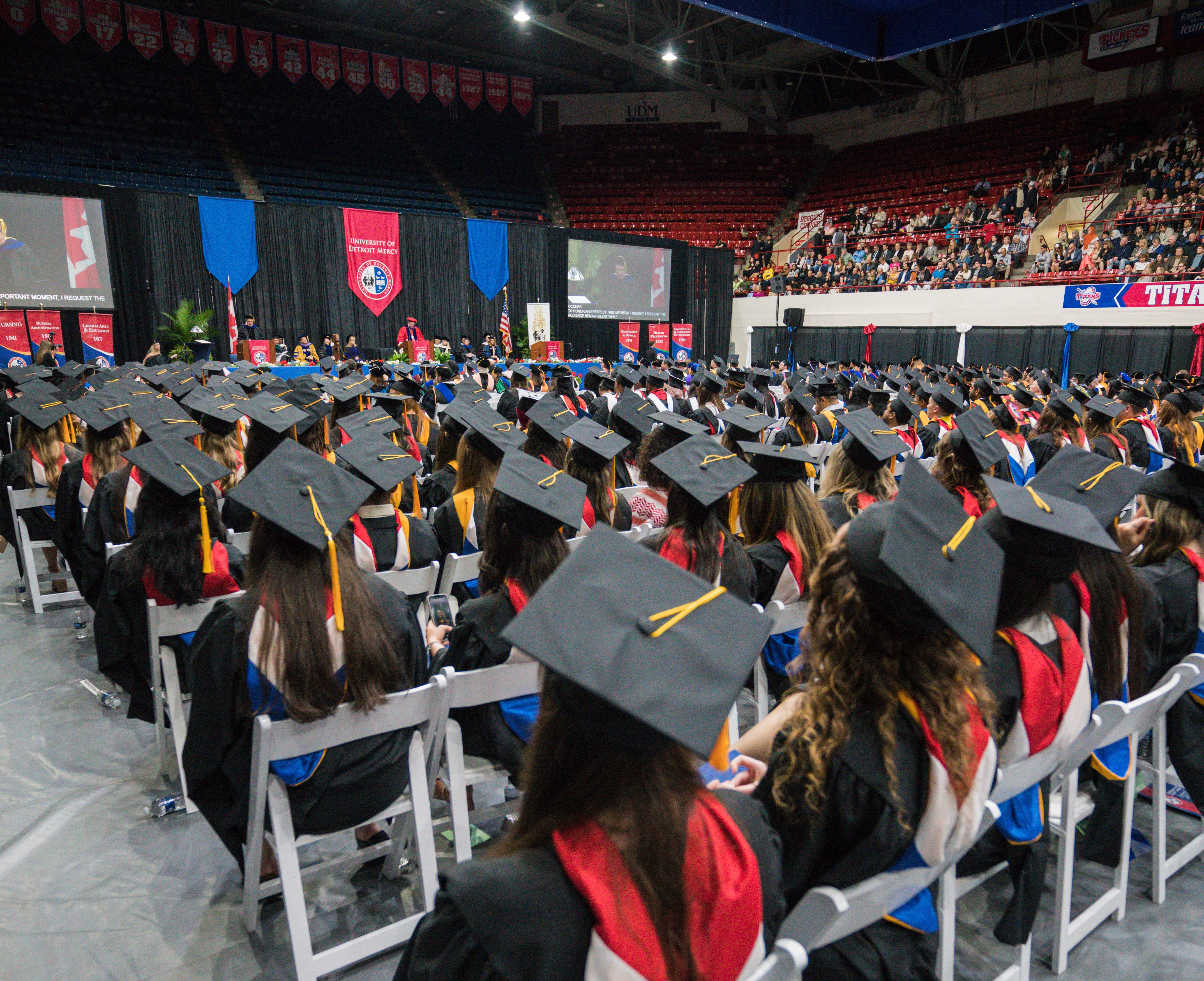 Back of graduates seated during ceremony