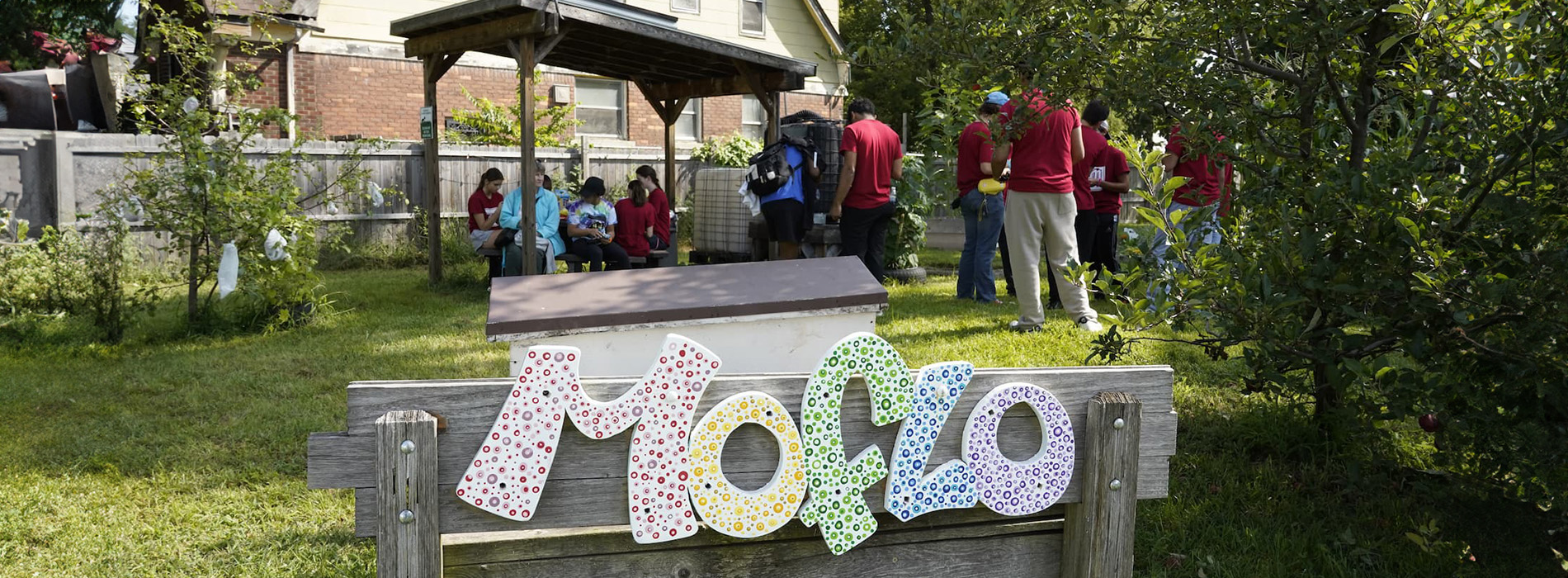 image of students in a garden with moflo sign