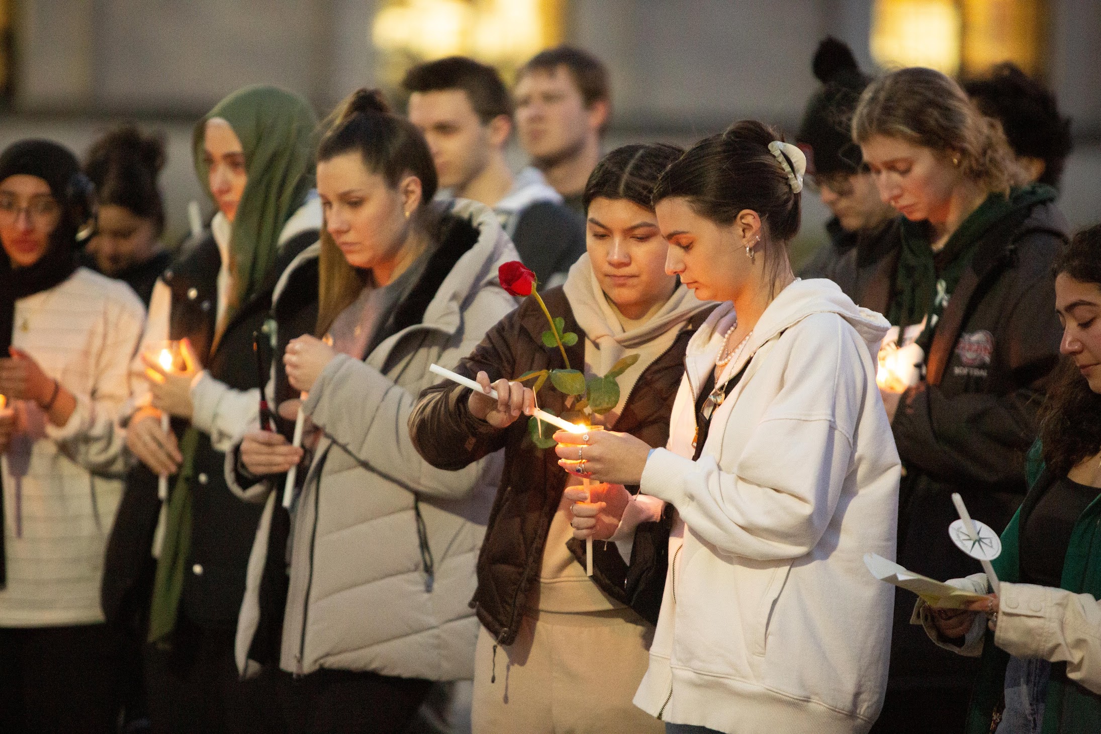 Students holding candles at a vigil 