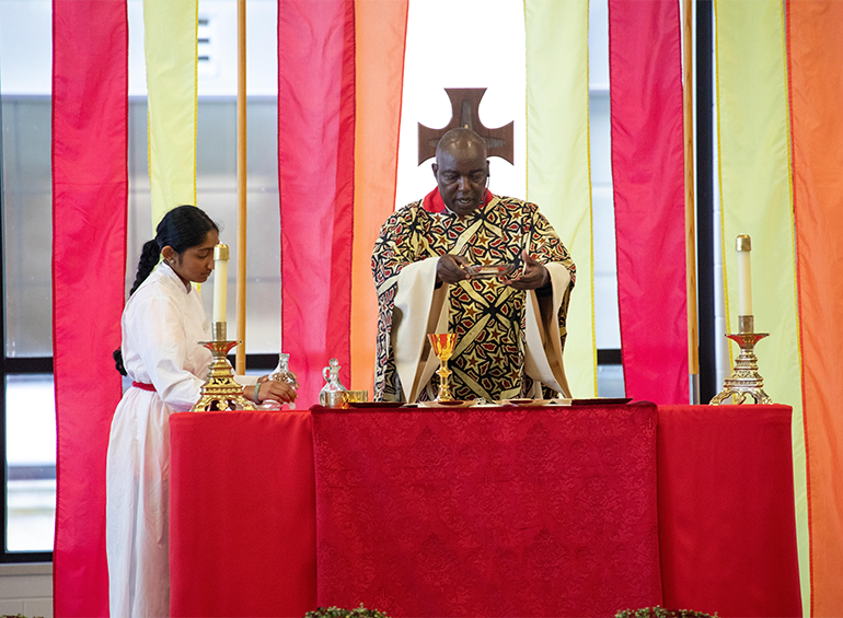 Image of Dr. Oduke performing Eucharistic blessing at altar